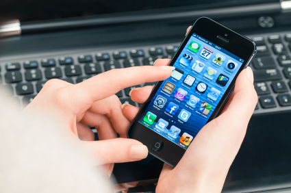 Man holding iPhone while working on a mobile app