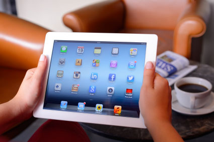 man holding an iPad while testing an application being developed